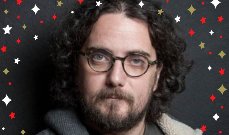 Ο Στάθης Δρογώσης, μας εύχεται δίπλα από το minimal χριστουγεννιάτικο δέντρο του